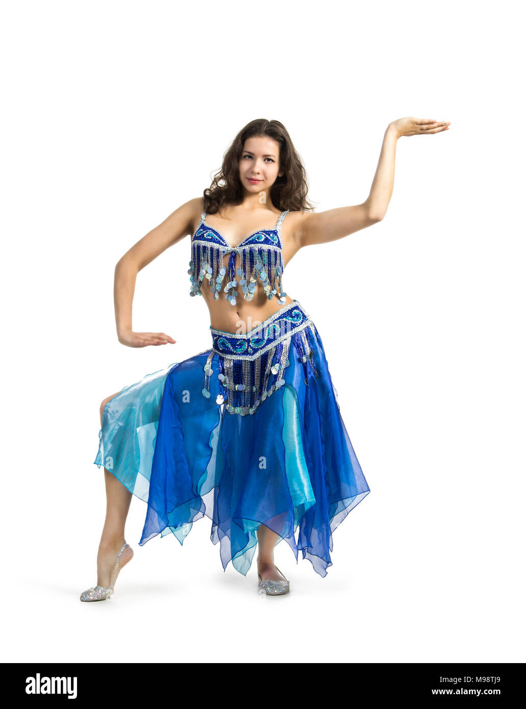 Smiling woman dancing the Eastern dance.The performance on the stage belly dancing. Shooting in Studio on white background isolated image. Stock Photo