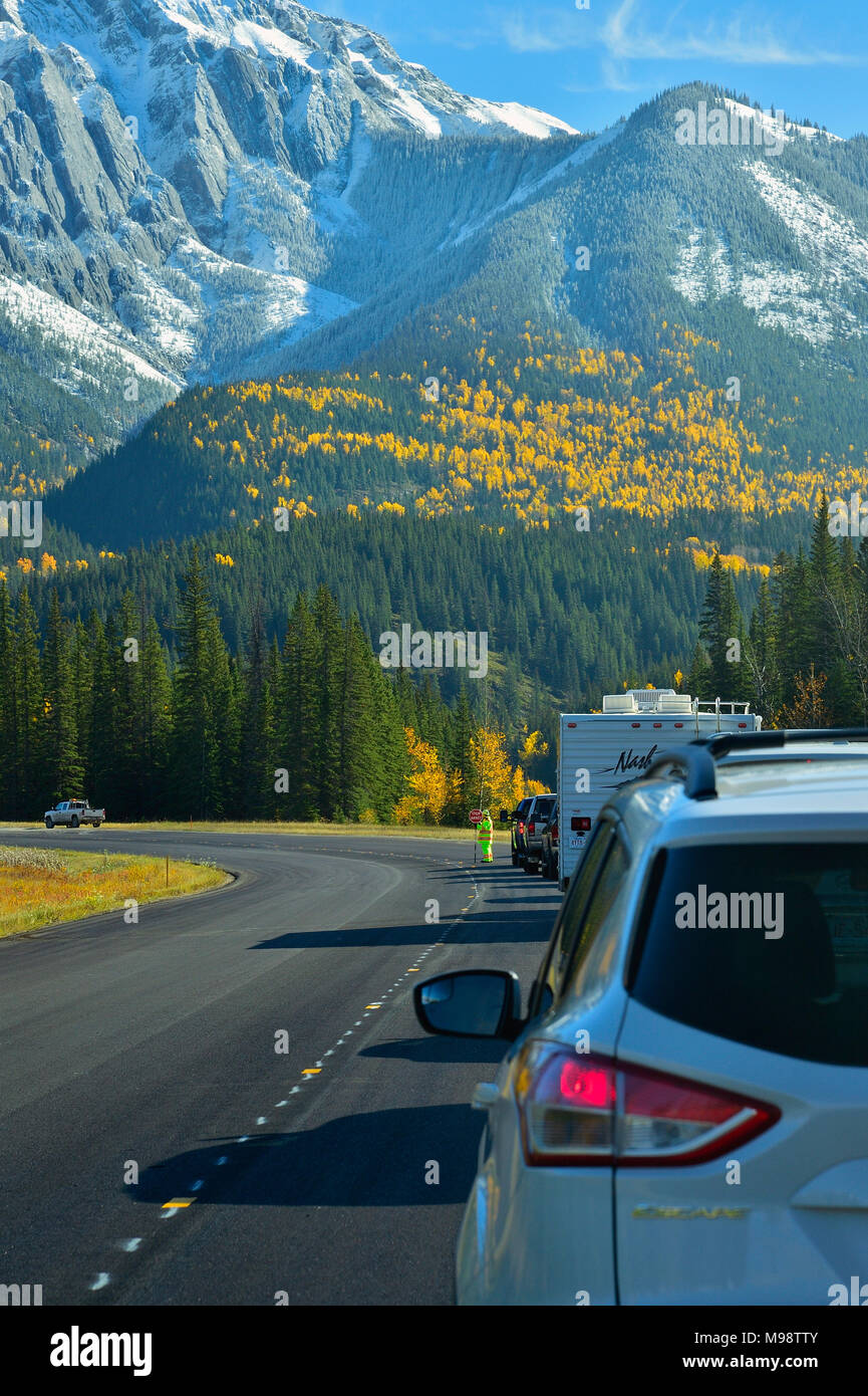 A vertical image of the highway going east of the town of Jasper with worker stopping the traffic because of repairs being done on the highway in Jasp Stock Photo
