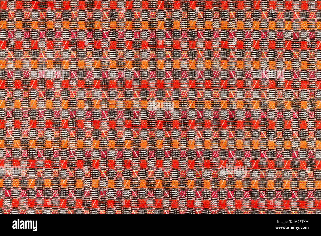 Fabric with a dark red ang orange background with geometric patterns ...