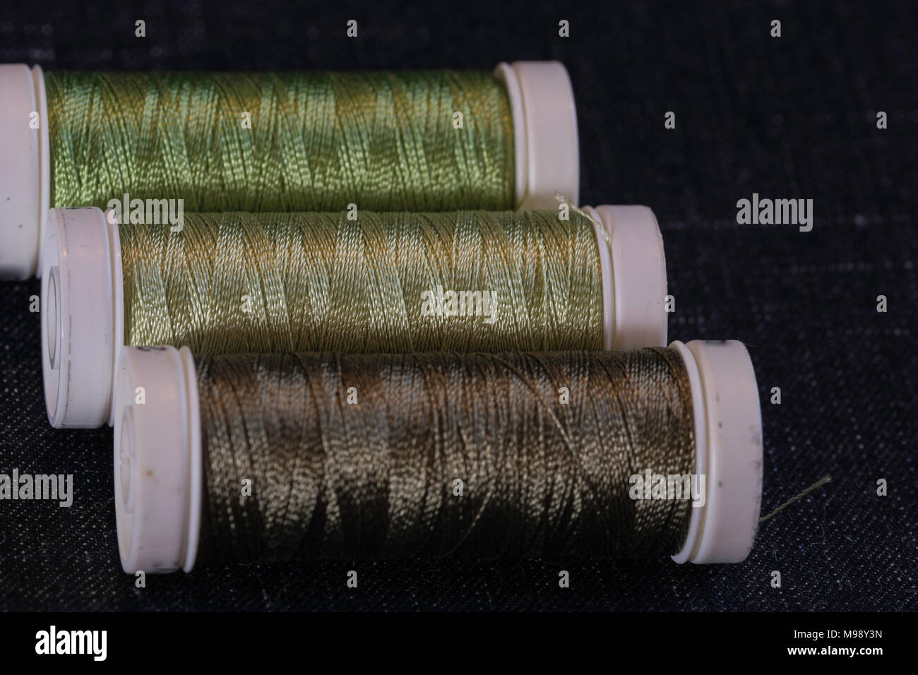 assorted spools of green sewing thread Stock Photo Alamy