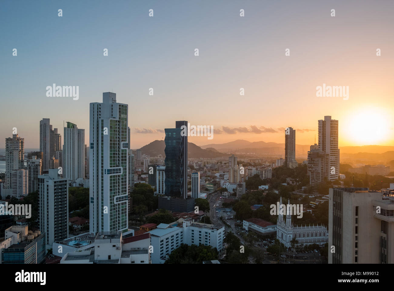 sunset sky over modern city skyline from high viewpoint  - Stock Photo