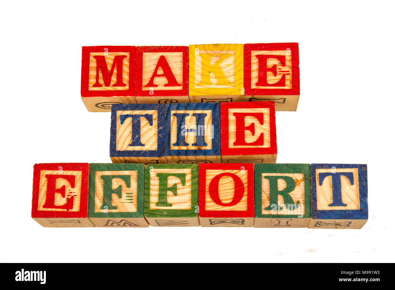 The term make the effort visually displayed on a white background using colorful wooden toy blocks image in landscape format Stock Photo