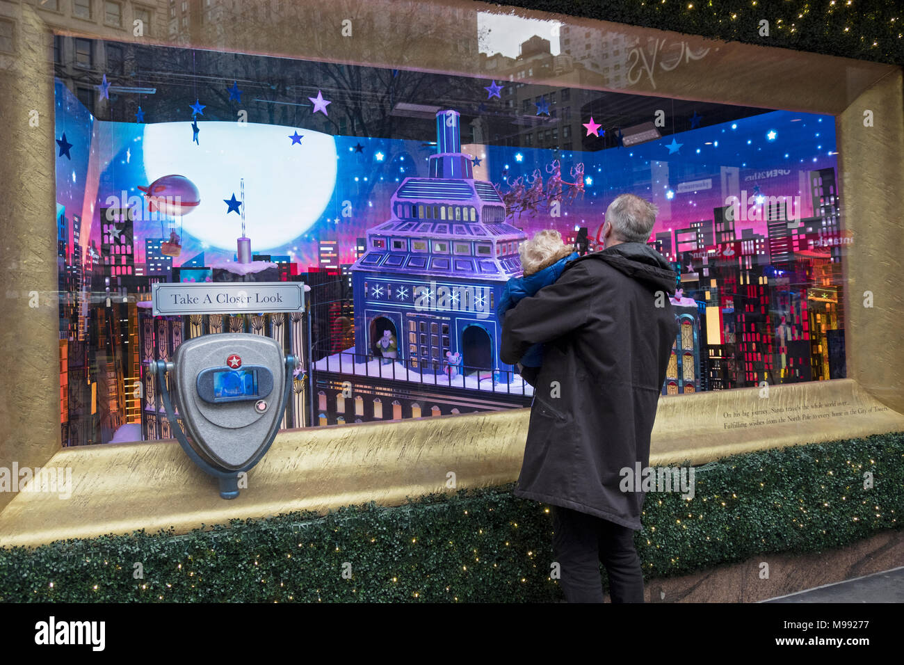 An anonymous grandfather shows his grandson a Macy's Christmas window at Herlad Square in Manhattan, New York City. Stock Photo