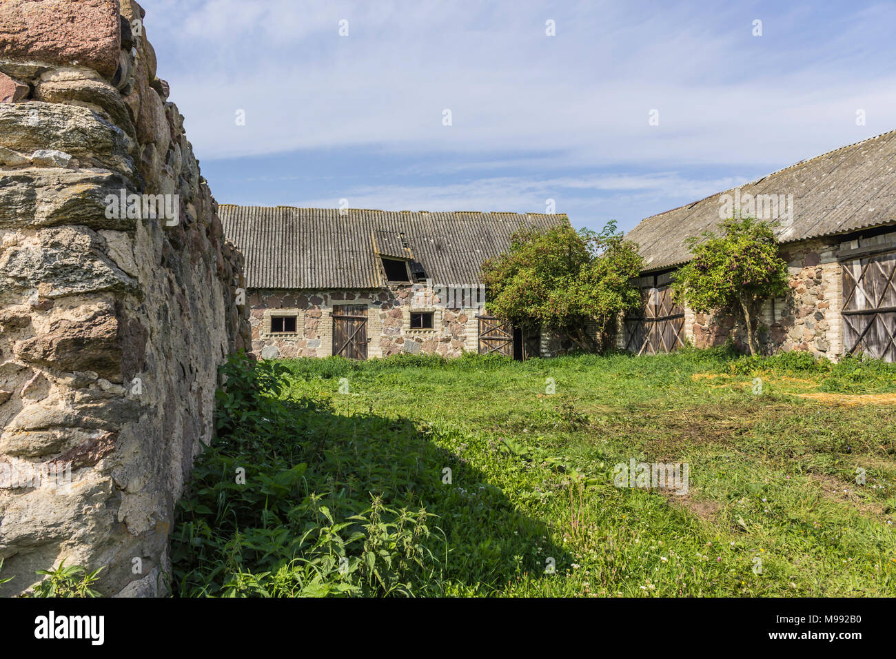 The farmyard is an agricultural abandoned farm. The old collapsed barns. The end of the summer