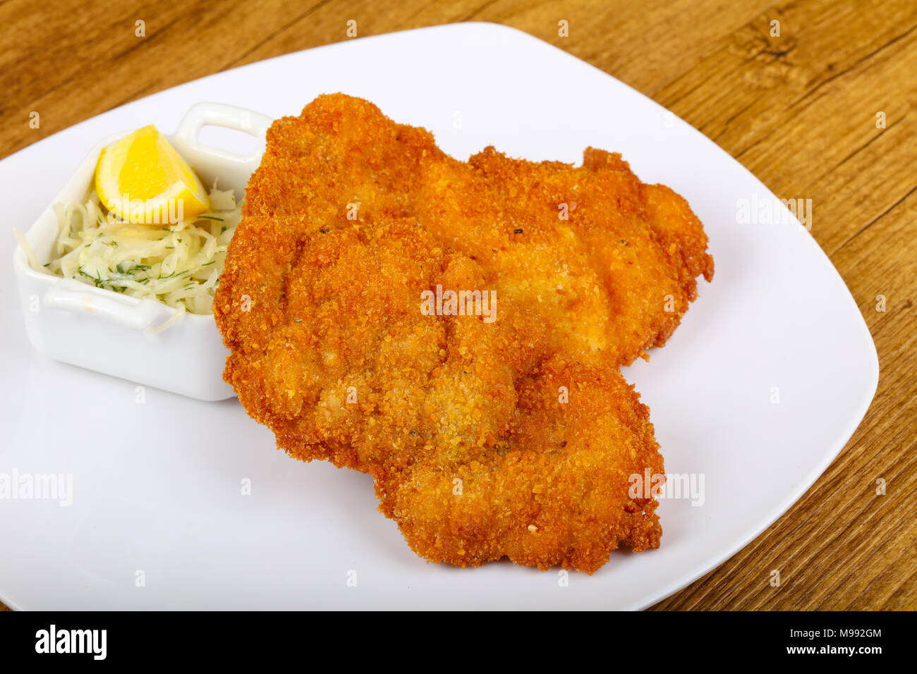 Czech cuisine - schnitzel with cabbage and lemon Stock Photo - Alamy
