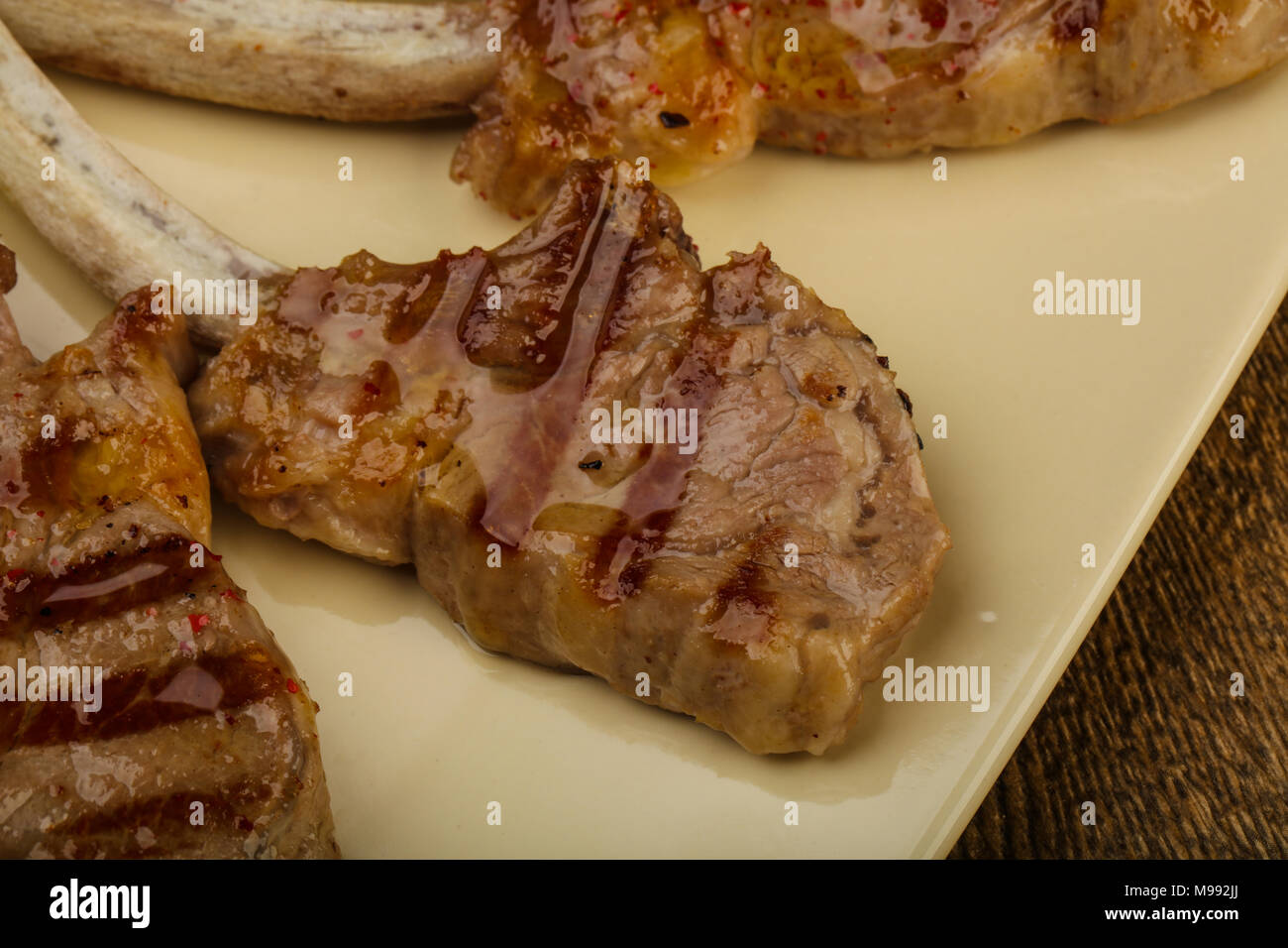 Grilled lamb with tomato sauce served salad leaves Stock Photo Alamy