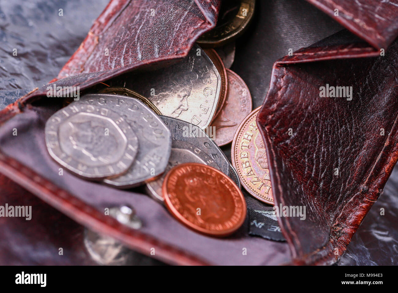 A small purse or change wallet in leather with coins inside Stock Photo
