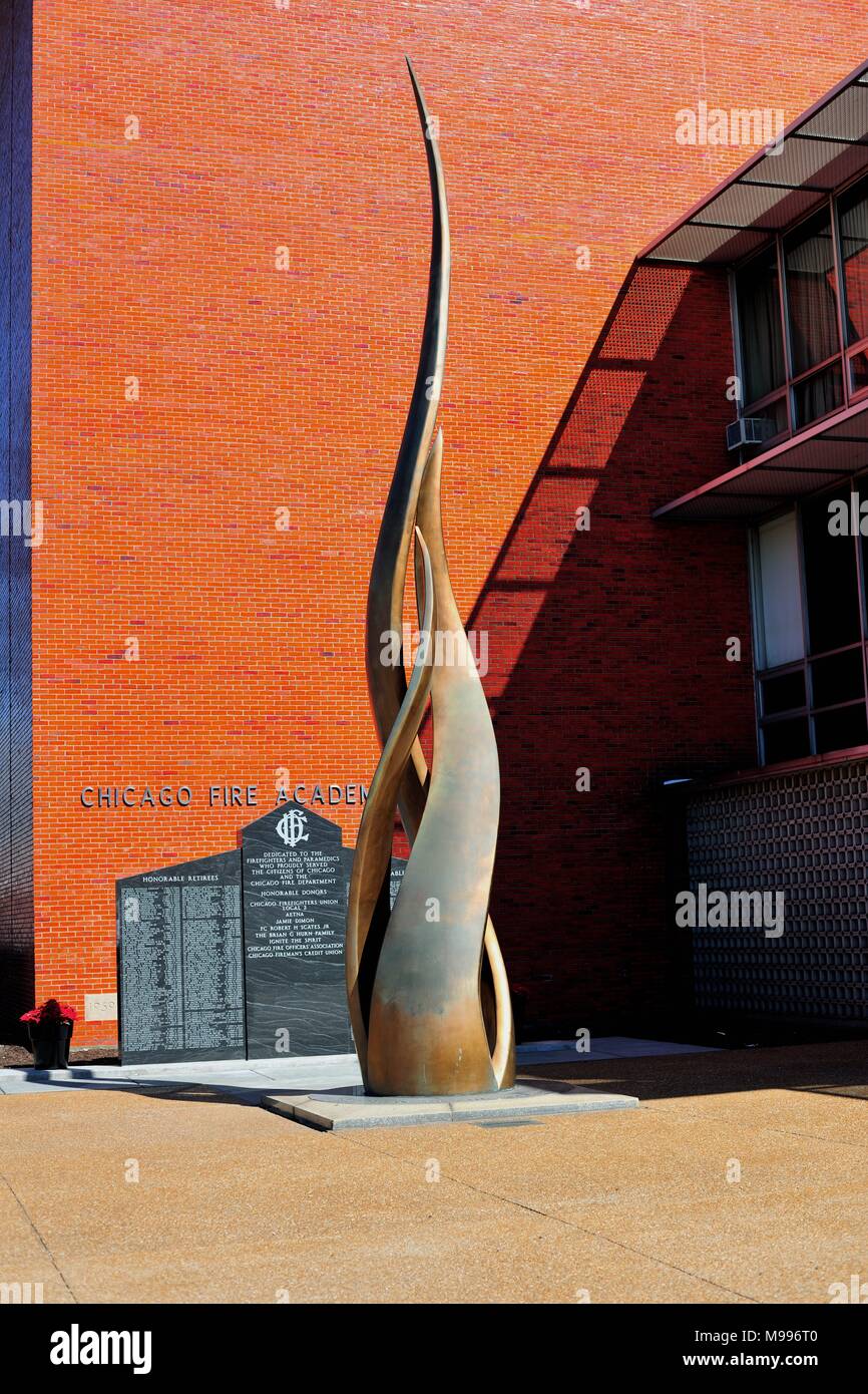 Chicago, Illinois, USA.  The bronze sculpture entitled Pillar of Fire by Egon Weiner sits in front of the Chicago Fire Academy. Stock Photo