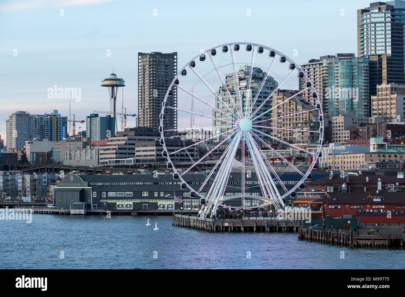 Seattle skyline waterfront at sunset with Seattle Space Needle, Seattle Great Wheel, Ferris Wheel, Seattle Washington. Stock Photo