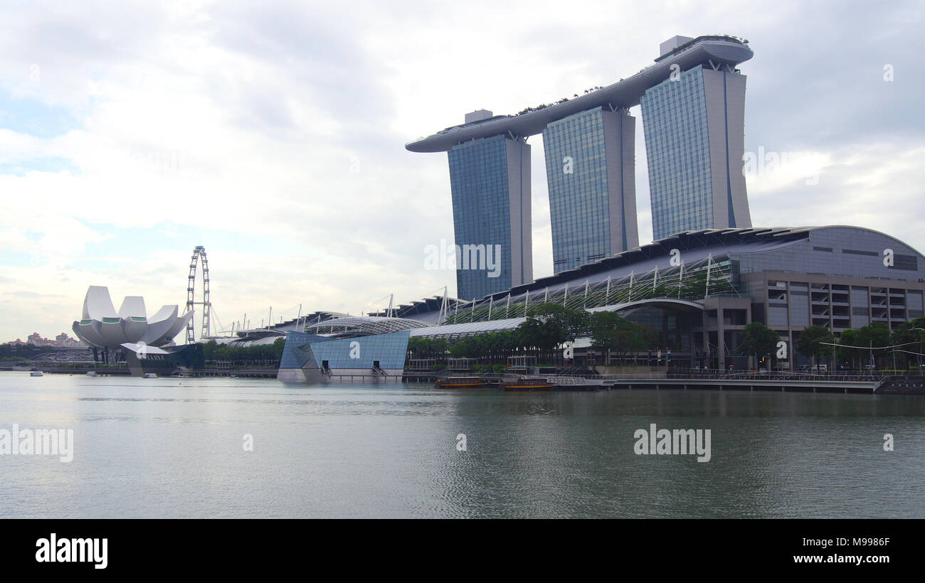 SINGAPORE - APR 1st, 2015: The Marina Bay Sands Resort in Singapore. The roofs of towers are decorated with a park in the form of a ship 340 m long and capacity up to 3,900 people Stock Photo