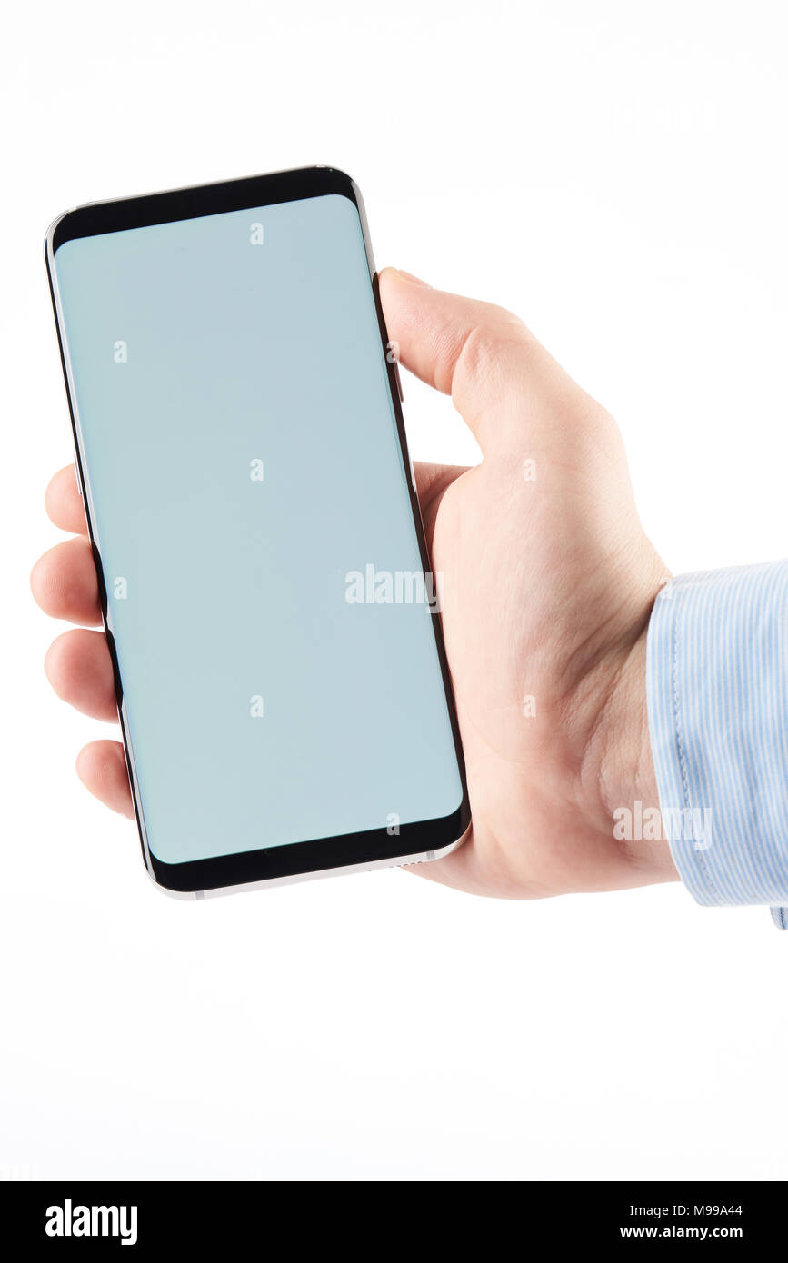 Showing smartphone in man hand isolated on white background Stock Photo ...