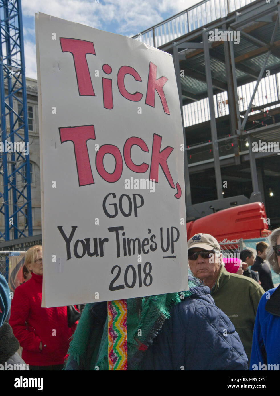 ASHEVILLE, NORTH CAROLINA - JANUARY 20, 2018: A women holds a sign saying 'Tick Tock, GOP Your Time's Up, 2018' during the 2018 Women's March promotin Stock Photo