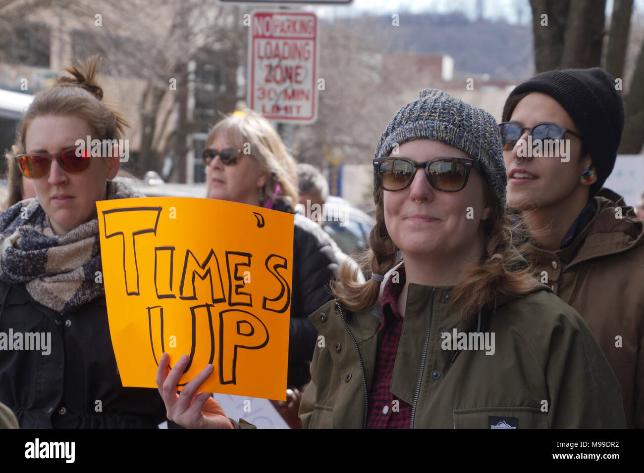 ASHEVILLE, NORTH CAROLINA - JANUARY 20, 2018: Women marching in the 2018 Women's March show a sign directed toward Trump, the GOP and sexism saying 'T Stock Photo