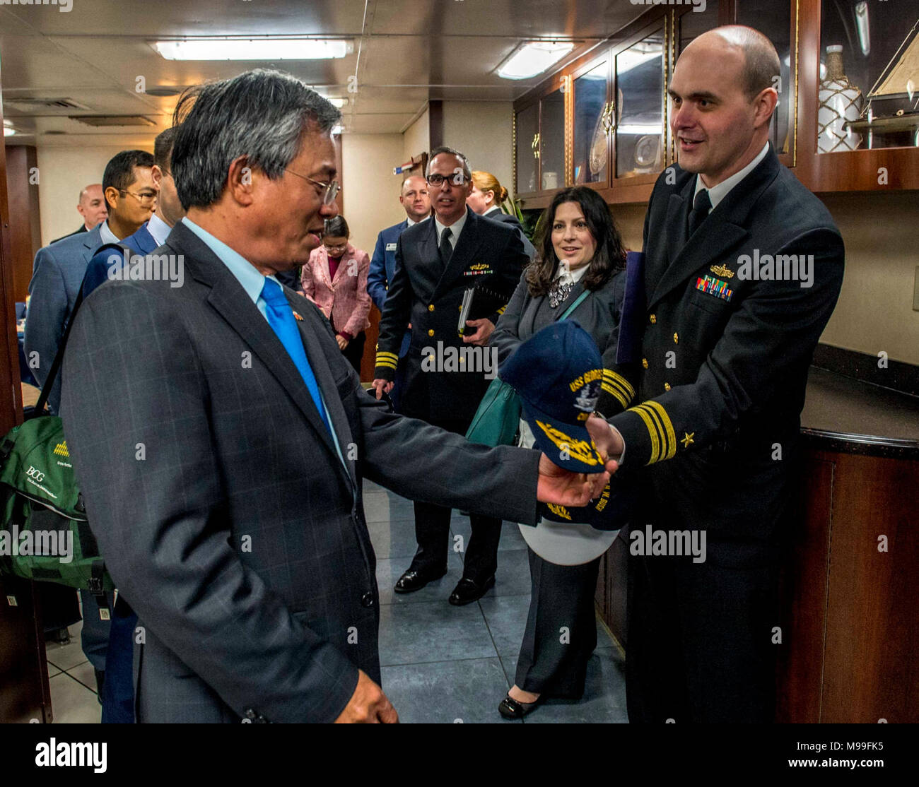 NORFOLK (Feb. 21, 2018) Lt. Cmdr. Robert Myers, right, presents a command ball cap to Ambassador of the Socialist Republic of Vietnam to the United States Pham Quang Vinh aboard the aircraft carrier USS George H. W. Bush (CVN 77). Vinh visited the ship to promote continued interoperability and a strong relationship between Vietnam and the U.S. The ship is in port in Norfolk, Va., conducting routine maintenance in preparation for the Board of Inspection and Survey (INSURV). (U.S. Navy Stock Photo