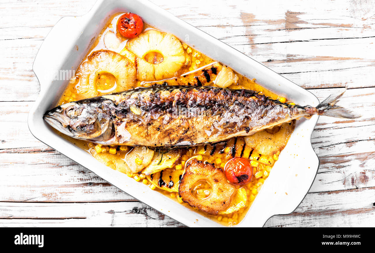 Roasted fish with pineapple and mango in pan Stock Photo