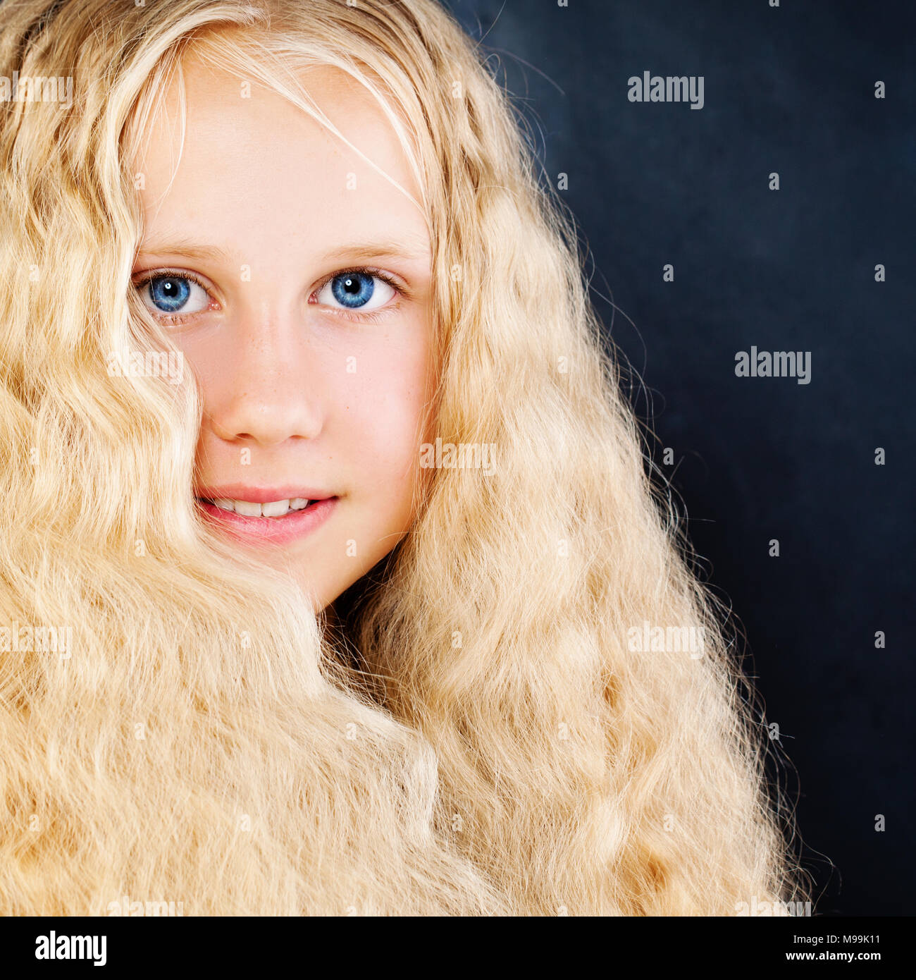 Pretty Child Girl On Blue Background Long Blonde Hair Face