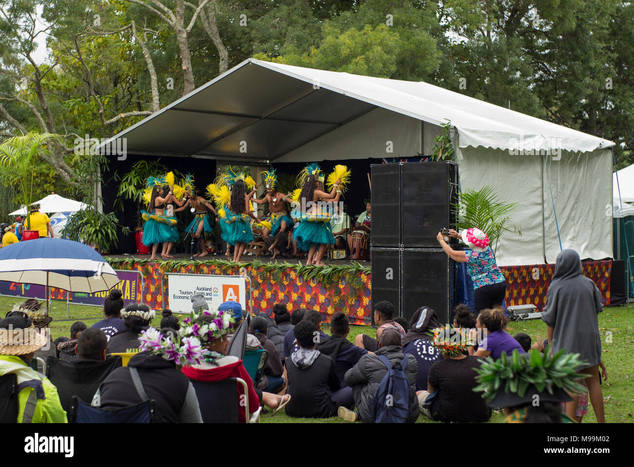 A group of Cook Islander dance in stage with an attentive audience at the Pasifica festival in Auckland. Stock Photo