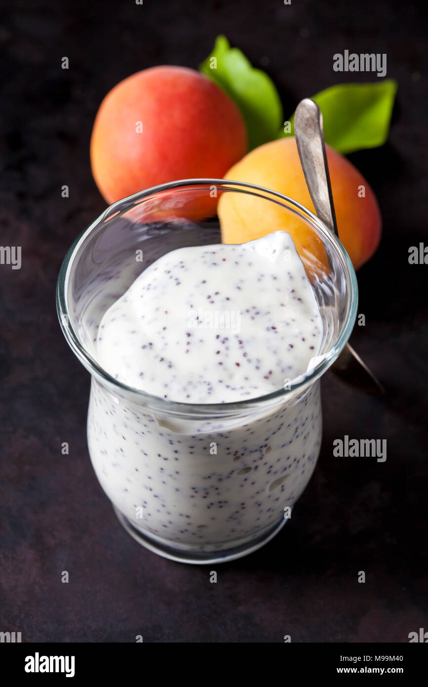 Glass of natural yoghurt with poppy seed Stock Photo