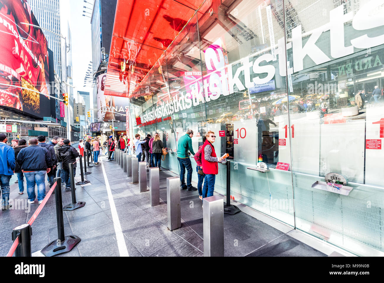 New York City, USA - October 28, 2017: Manhattan NYC buildings of midtown Times Square, Broadway avenue road, signs for ticket sales, many people buyi Stock Photo