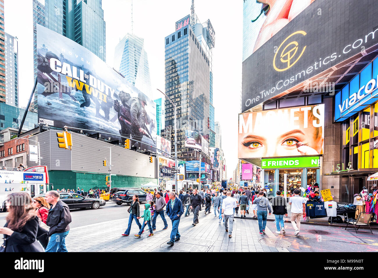 New York City, USA - October 28, 2017: Manhattan NYC buildings of midtown Times Square, Broadway avenue road, signs ads, many large huge crowd of peop Stock Photo