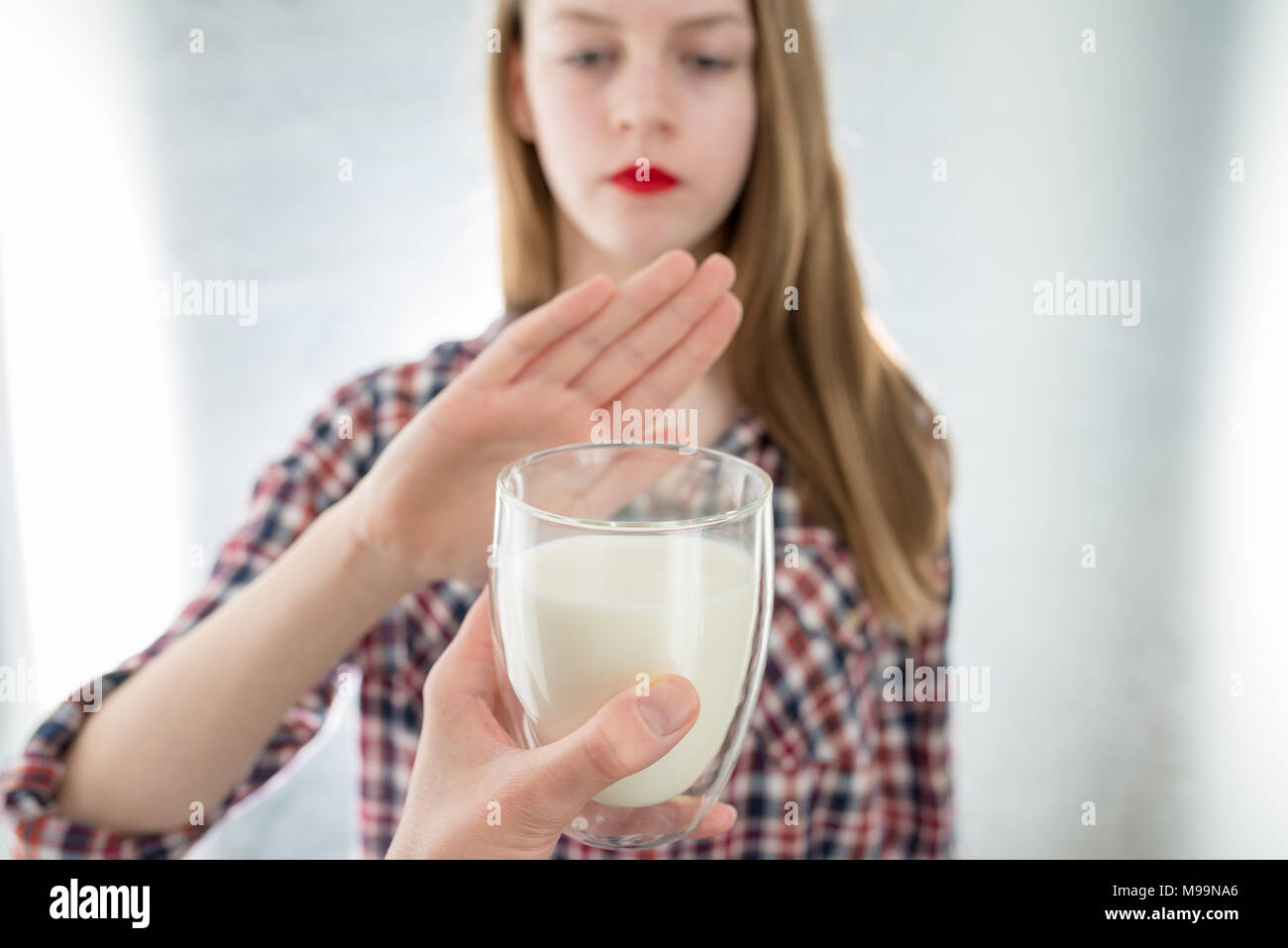 Lactose intolerance. Dairy Intolerant young girl refuses to drink milk