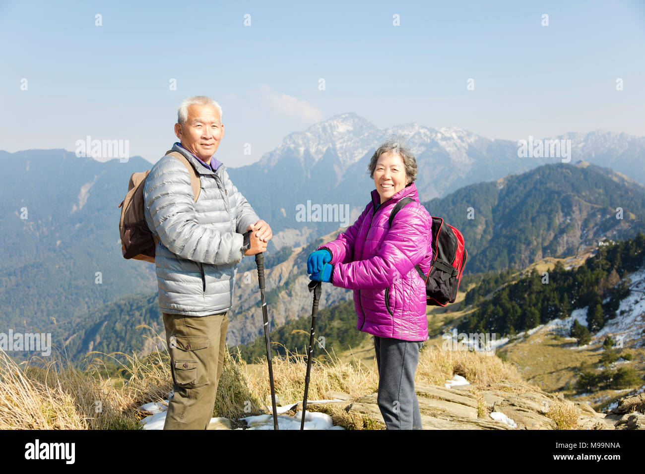happy senior couple hiking on the mountain Stock Photo - Alamy