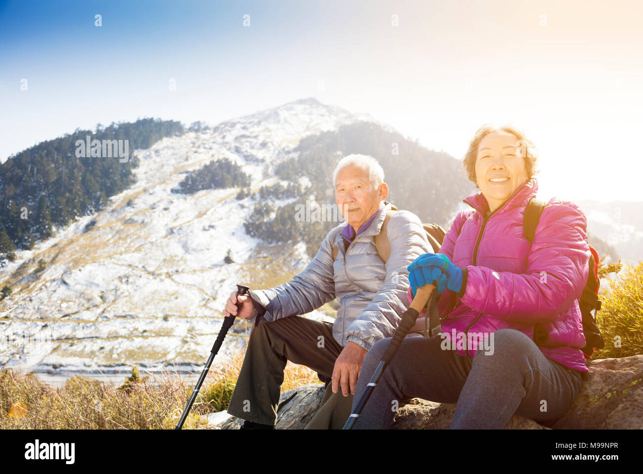 happy senior couple hiking on the mountain Stock Photo - Alamy