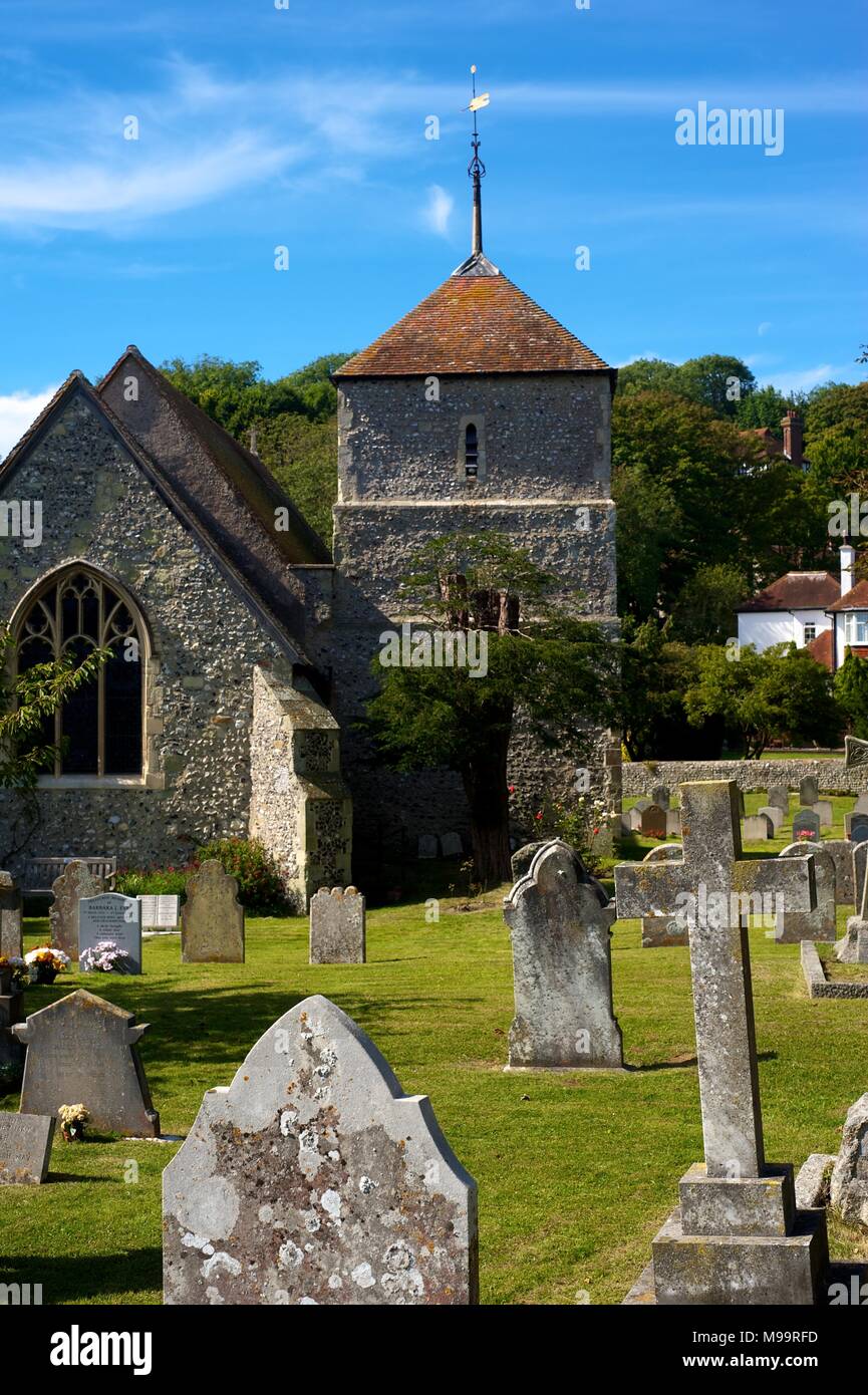 Village church and gravestones in the beautiful village of East Dean, Sussex, England, on a summer day Stock Photo