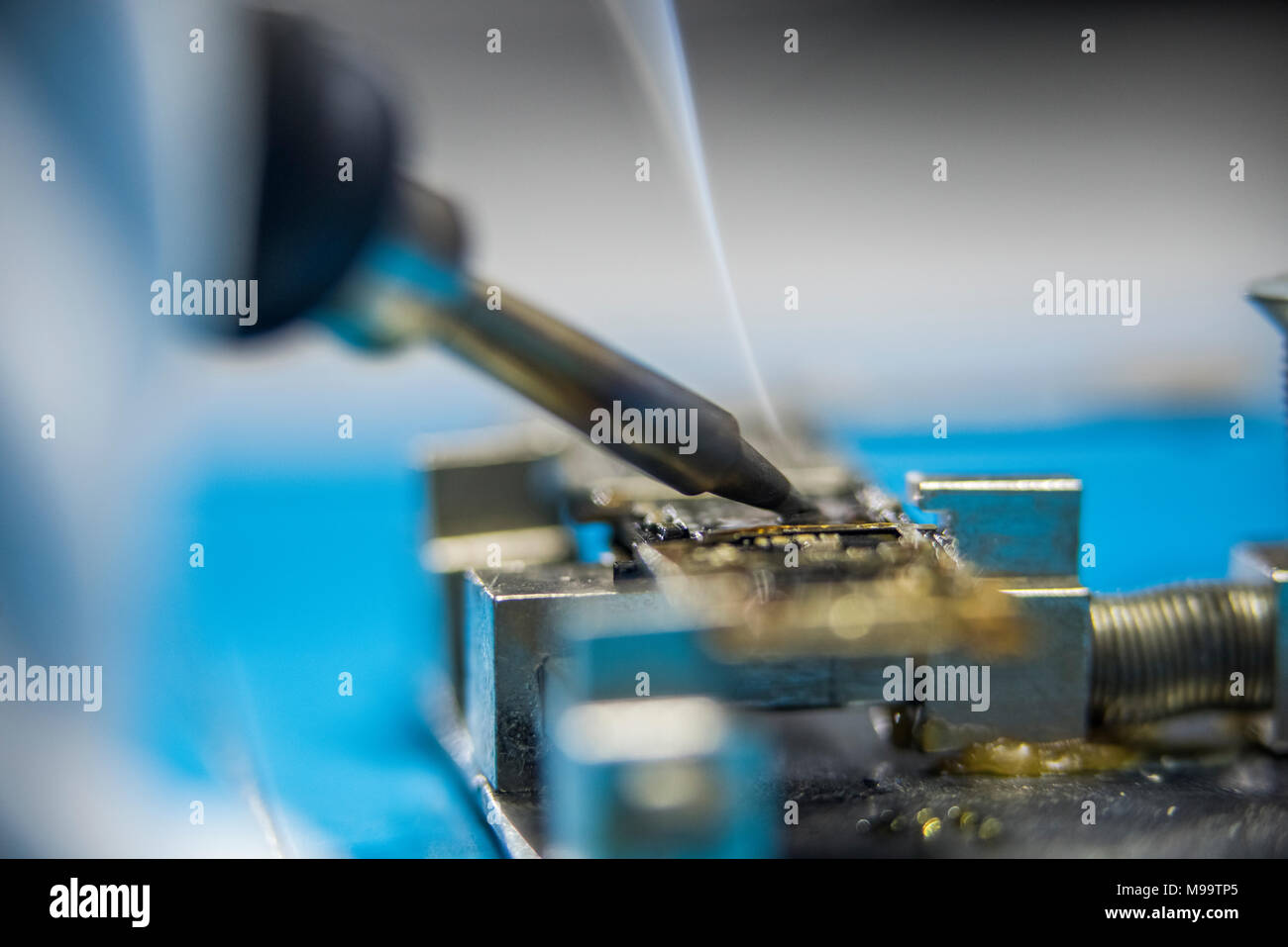 Reparing electronics devices, hands and tools, mobiles and computers Stock Photo