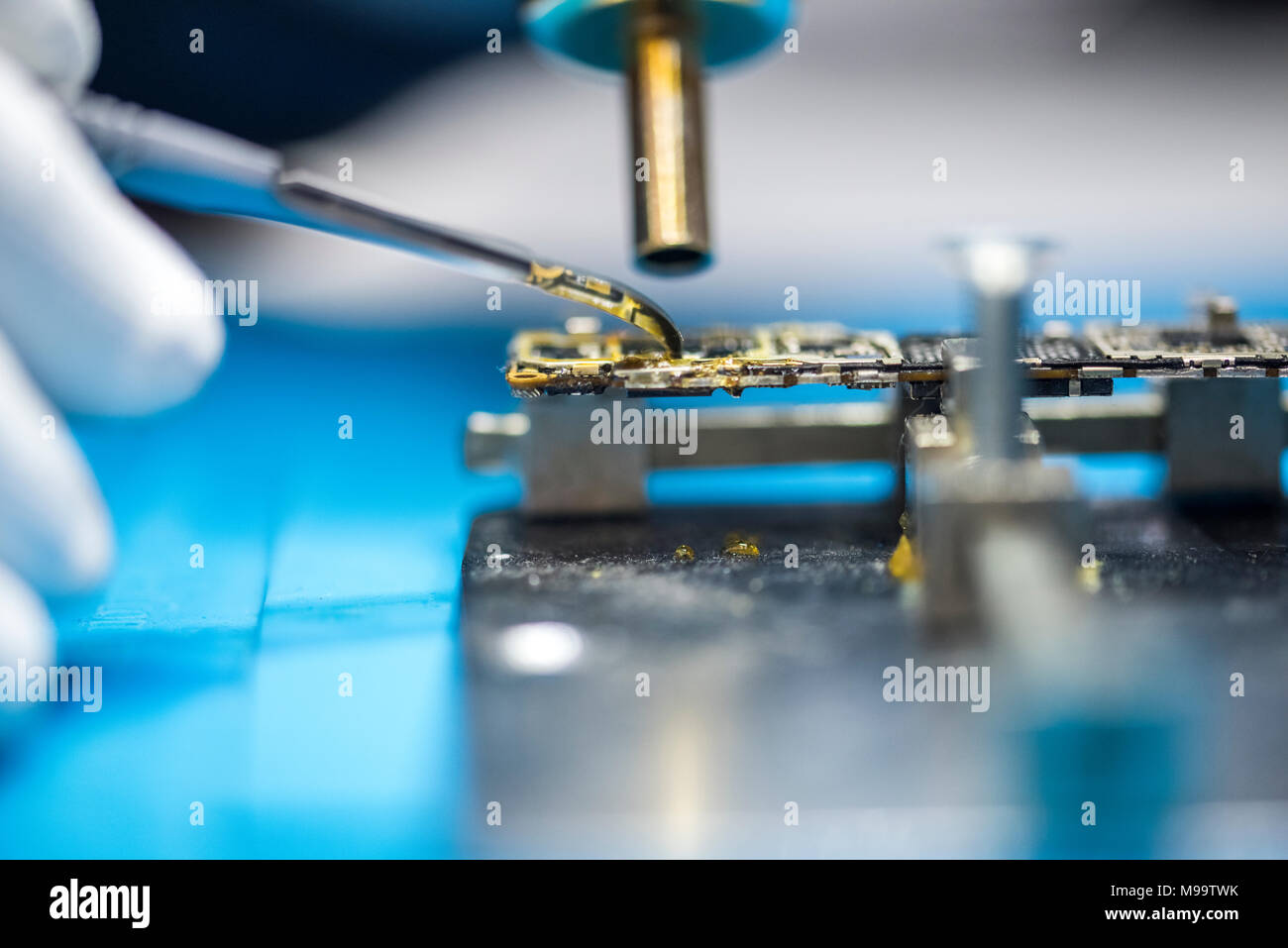 Reparing electronics devices, hands and tools, mobiles and computers Stock Photo
