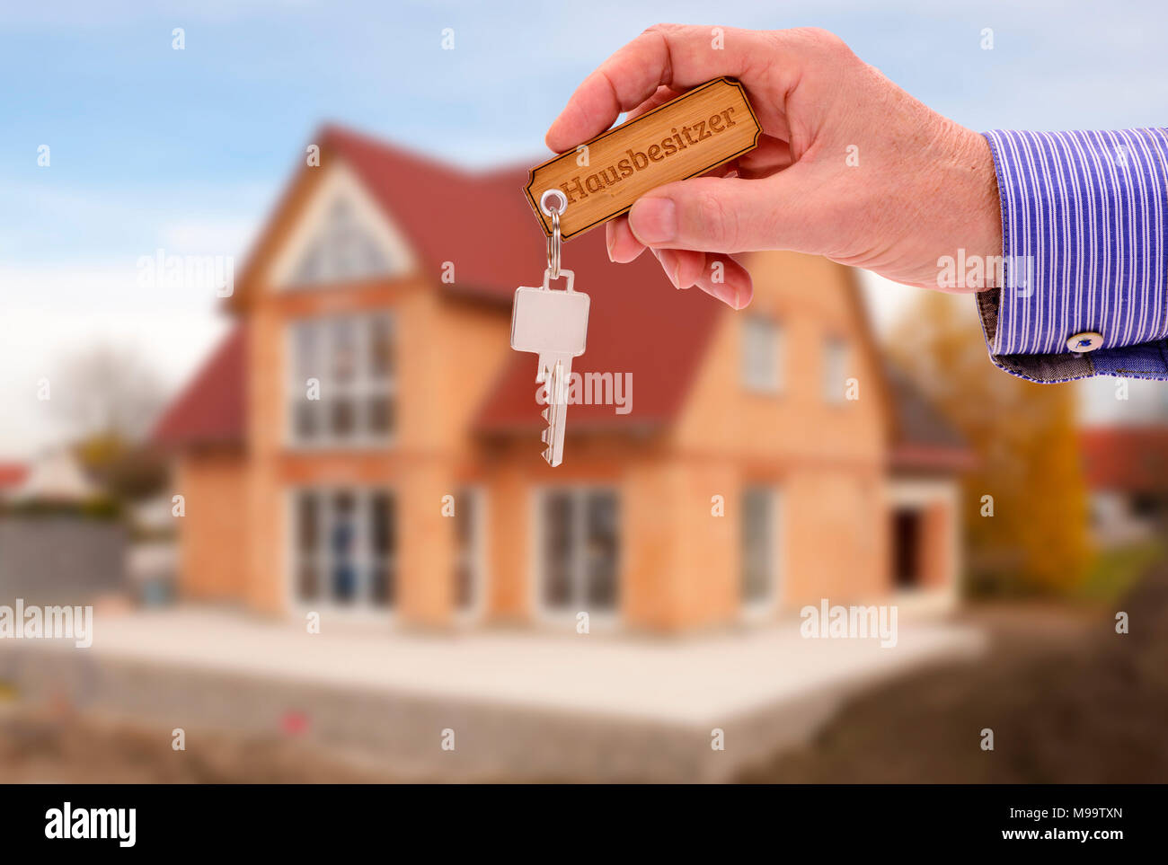key in hand of real estate agent as offer for new residential home Stock Photo
