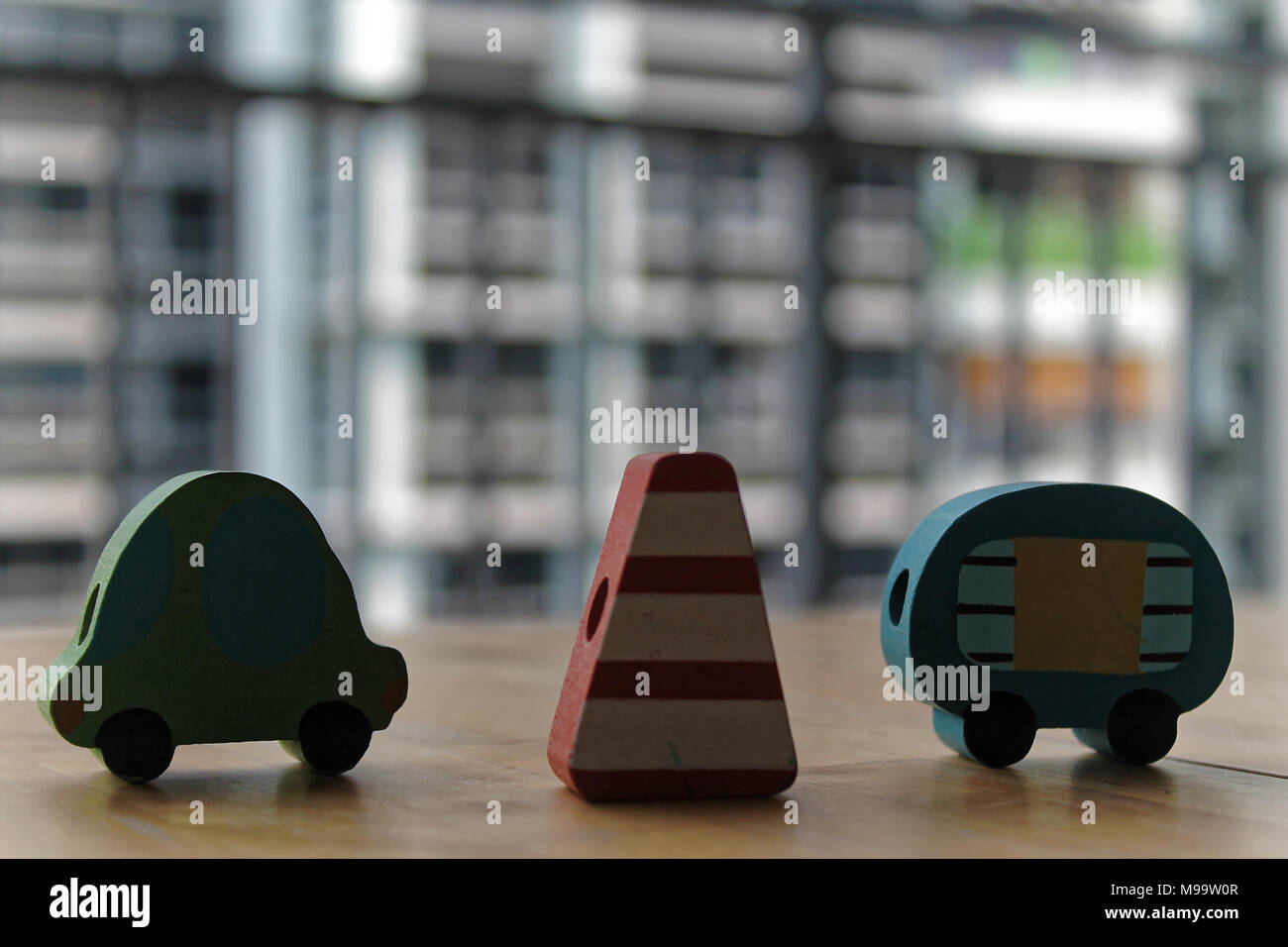 Wooden toy cars with traffic pylon on the table. Stock Photo