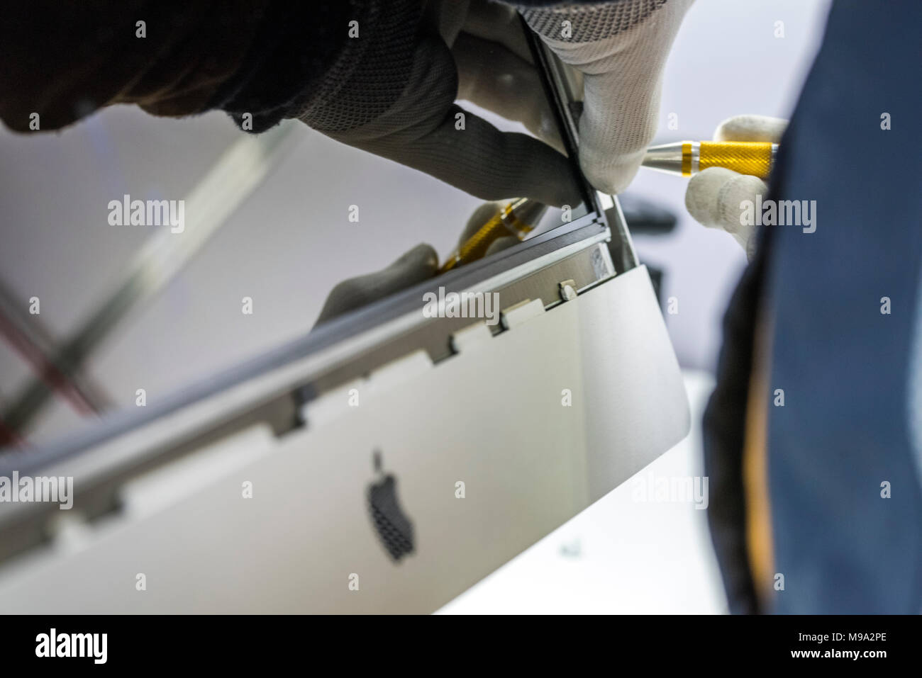 Reparing electronics devices, hands and tools, mobiles and computers. Mac reparing Stock Photo