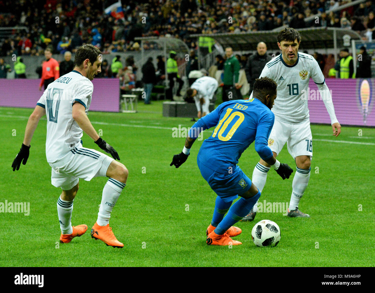 Moscow, Russia - March 23, 2018. Russian players Alan Dzagoev and Yuri Zhirkov against Brazilian striker Fred during international test match Russia vs Brazil in Moscow. Credit: Alizada Studios/Alamy Live News Stock Photo