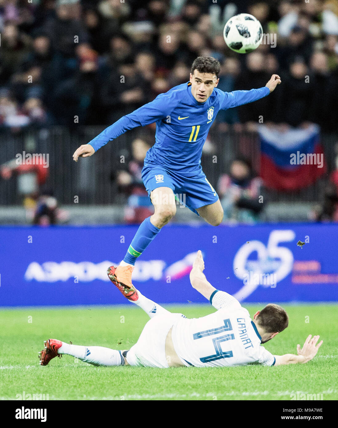 Moscow, Russia. 23rd Mar, 2018. Philippe Coutinho (Top) of Brazil is tackled by Vladimir Granat of Russia during the international friendly match between Russia and Brazil at Luzhniki Stadium in Moscow, Russia, on March 23, 2018. Brazil won 3-0. Credit: Wu Zhuang/Xinhua/Alamy Live News Stock Photo