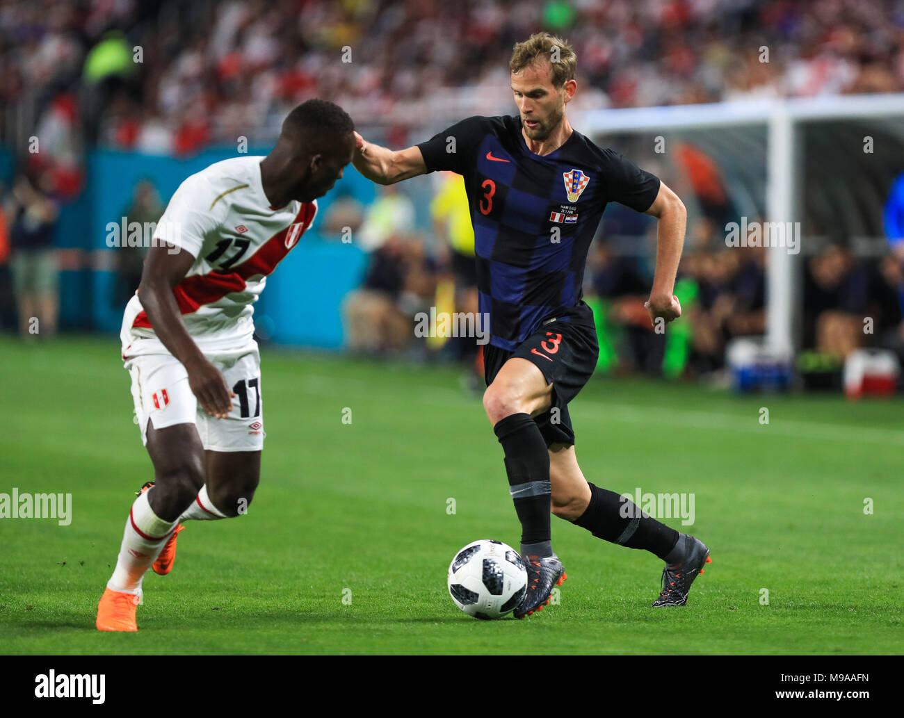 Miami Gardens, Florida, USA. 23rd Mar, 2018. Croatia defender Ivan Strinic (3) drives the ball challenged by Peru defender Luis Advincula (17) during a FIFA World Cup 2018 preparation match between the Peru National Soccer Team and the Croatia National Soccer Team at the Hard Rock Stadium in Miami Gardens, Florida. Credit: Mario Houben/ZUMA Wire/Alamy Live News Stock Photo