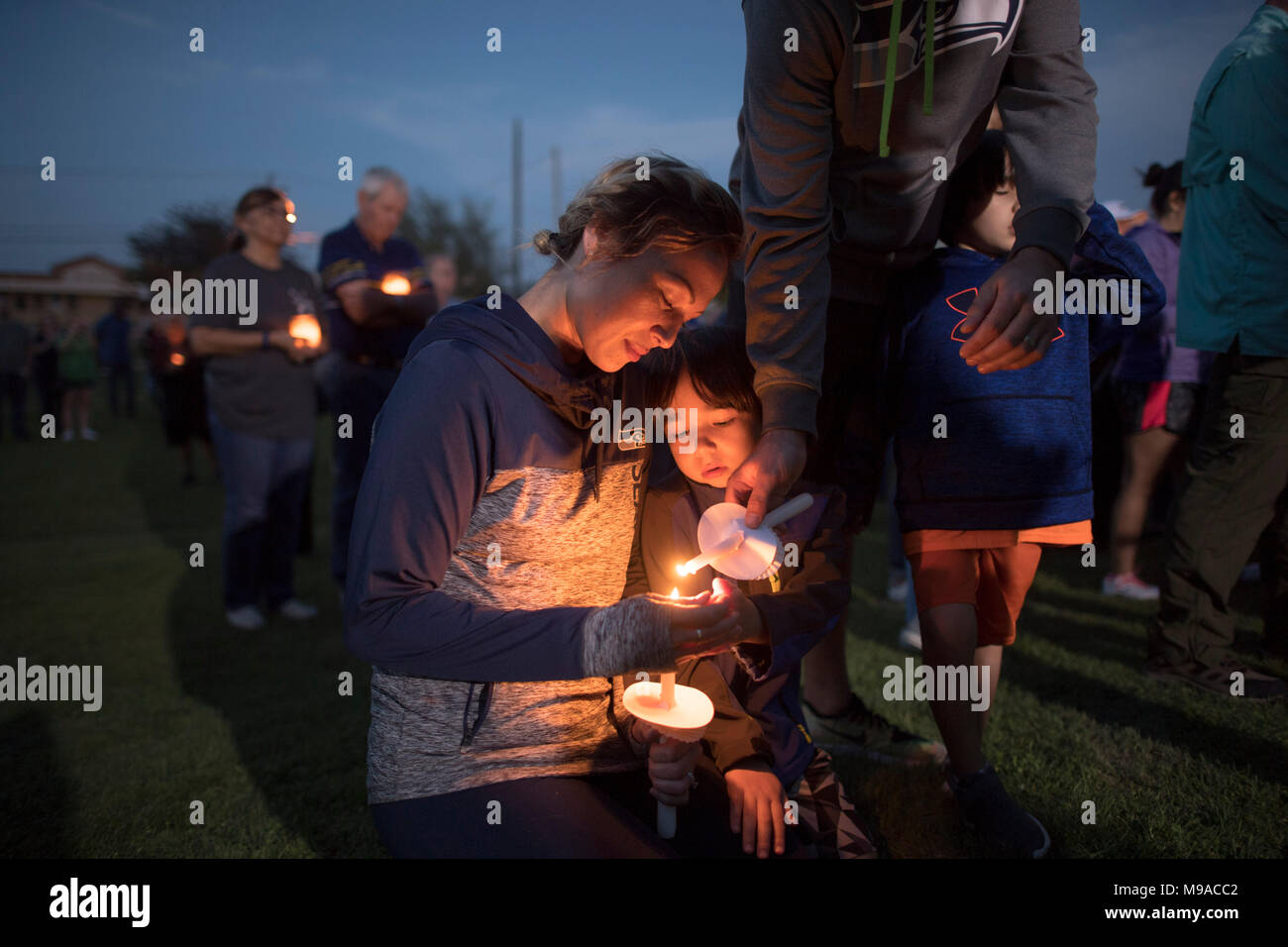 Cathrina and Cylus Rencken mourn at a candlelight vigil in Pflugerville, TX, for the victims of recent Austin package bombs, and to pray for the family of Mark A. Conditt, a resident accused of masterminding the attacks Stock Photo