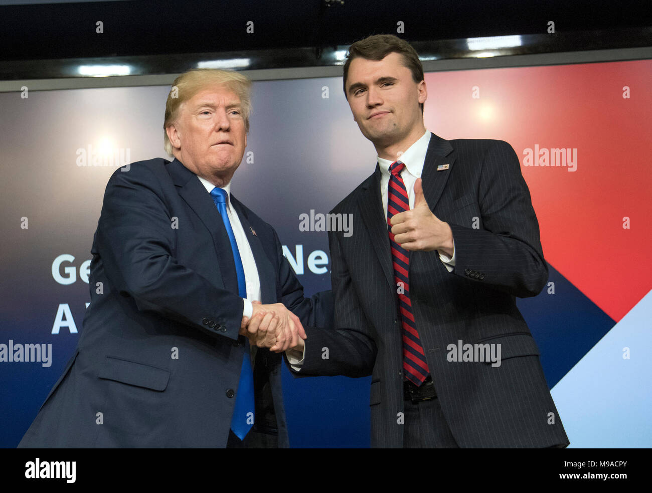 Washington, USA. 22nd Mar, 2018. United States President Donald J. Trump, left, shakes hands with with Charlie Kirk, Founder and Executive Director of Turning Point USA, right, after participating in a panel discussion, at the Generation Next Summit at the White House in Washington, DC on Thursday, March 22, 2018. Credit: Ron Sachs/CNP - NO WIRE SERVICE · Credit: Ron Sachs/Consolidated News Photos/Ron Sachs - CNP/dpa/Alamy Live News Stock Photo