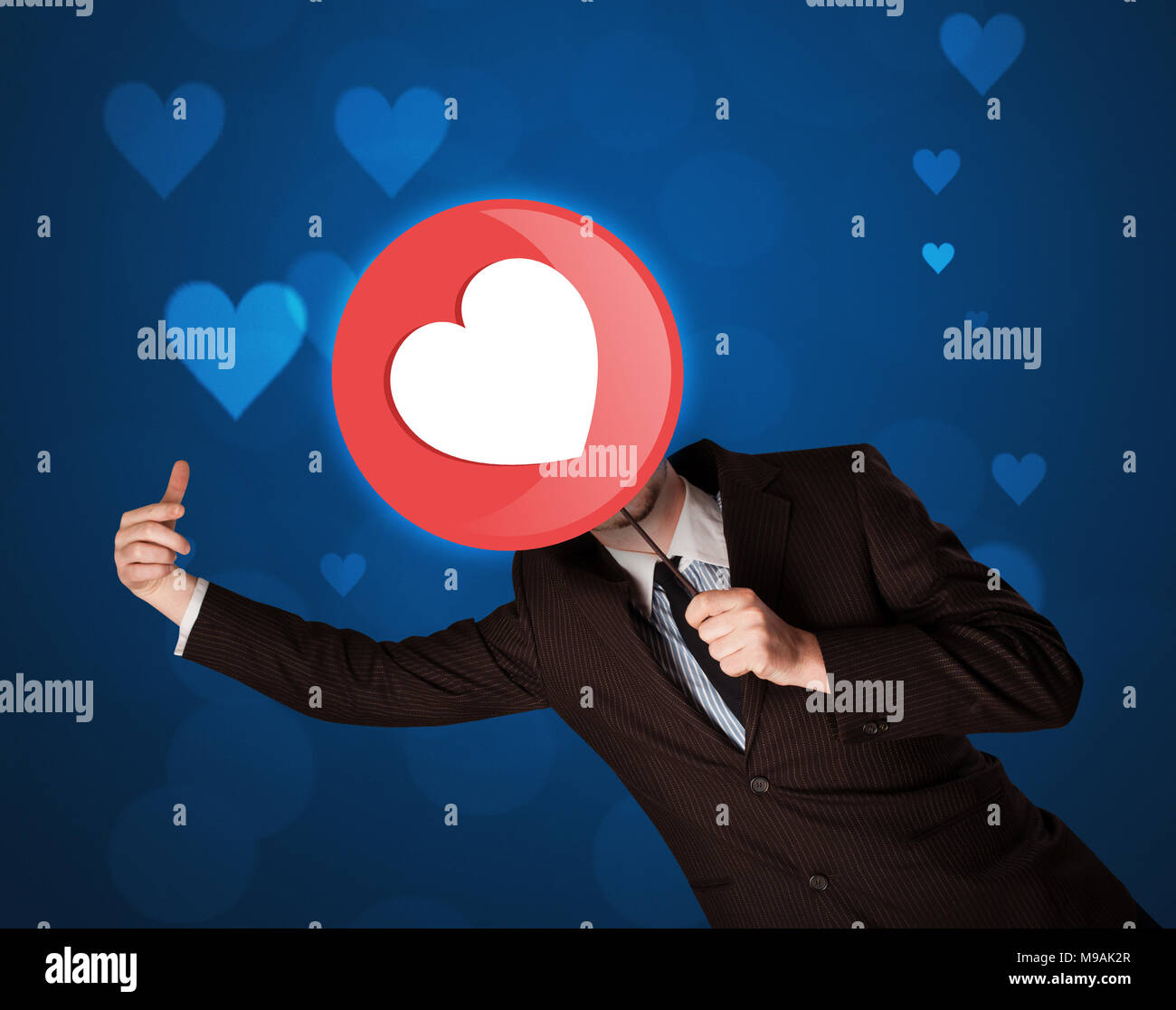 Smart businessman holding round sign with heart Stock Photo Alamy