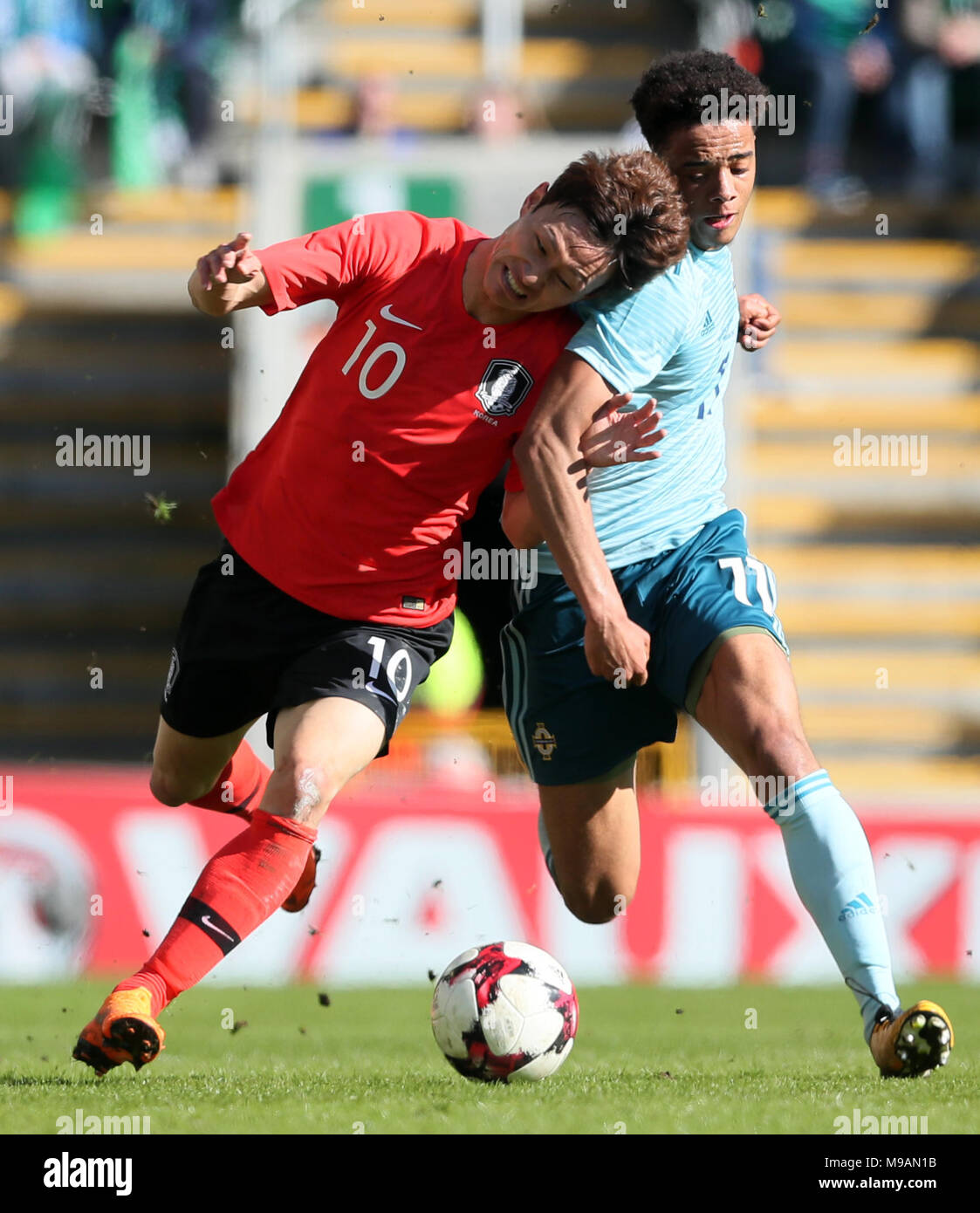 Northern Ireland's Jamal Lewis (right) and South Korea's Jae-Sung Lee battle for the ball during the international friendly match at Windsor Park, Belfast. Stock Photo