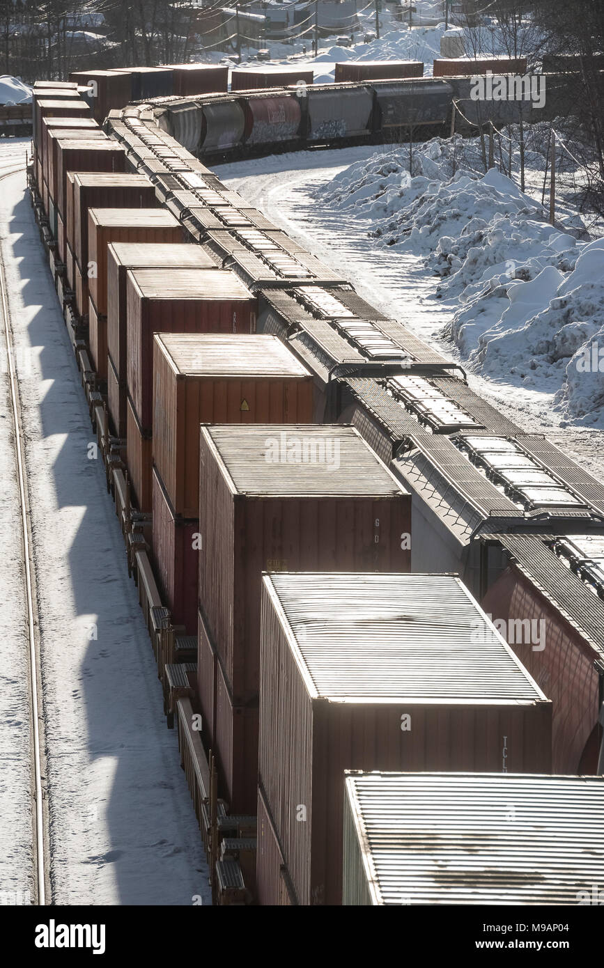 CPR intermodal and grain trains pass in winter at Revelstoke BC Stock Photo
