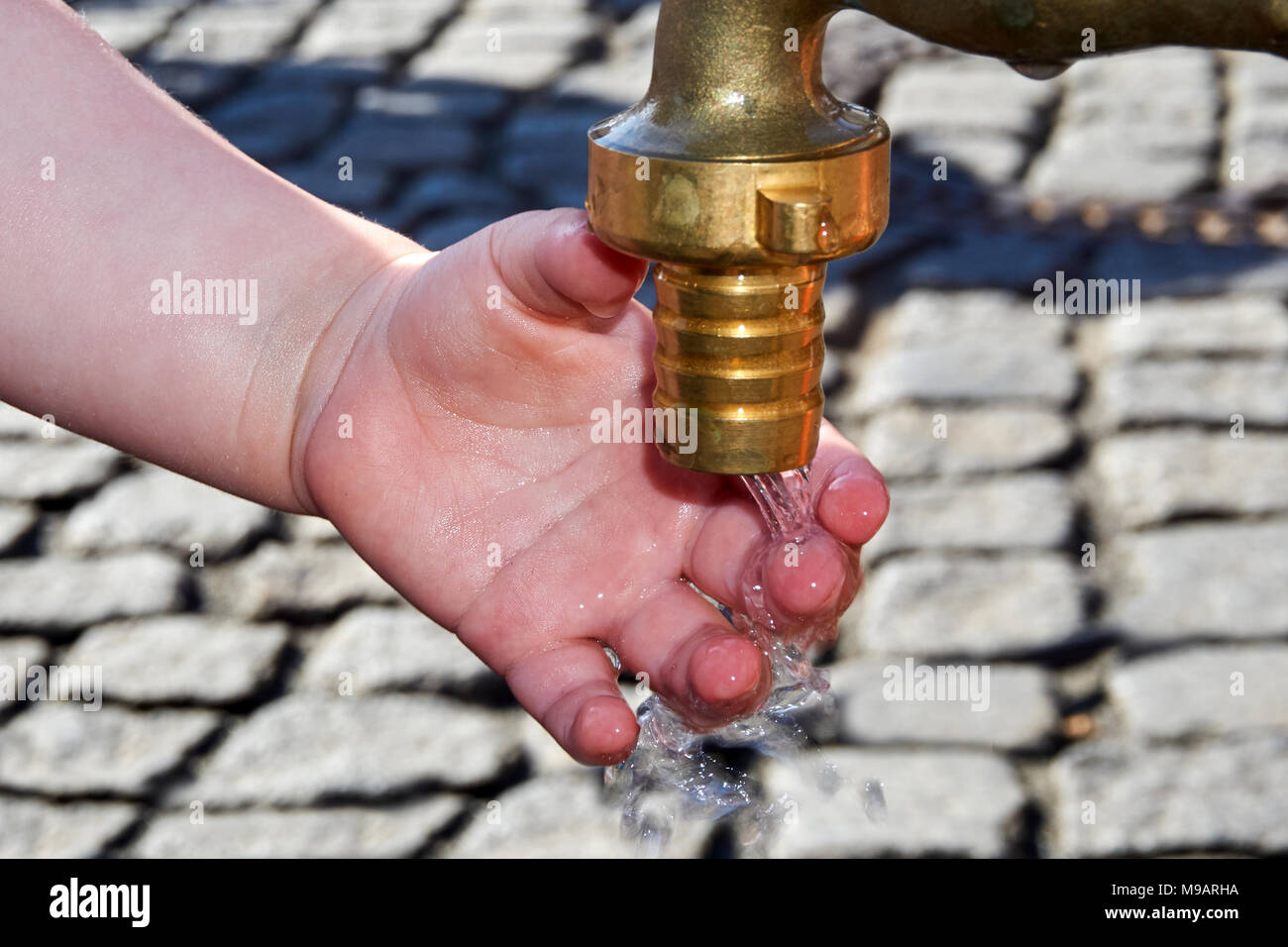 thirsty kids hand on water tap Stock Photo Alamy