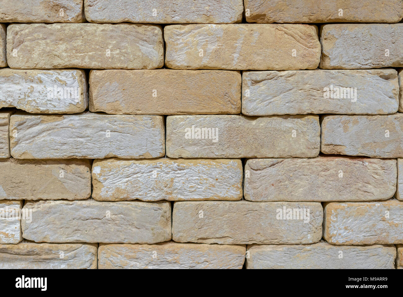 Wall of an old uneven light brick. background Stock Photo