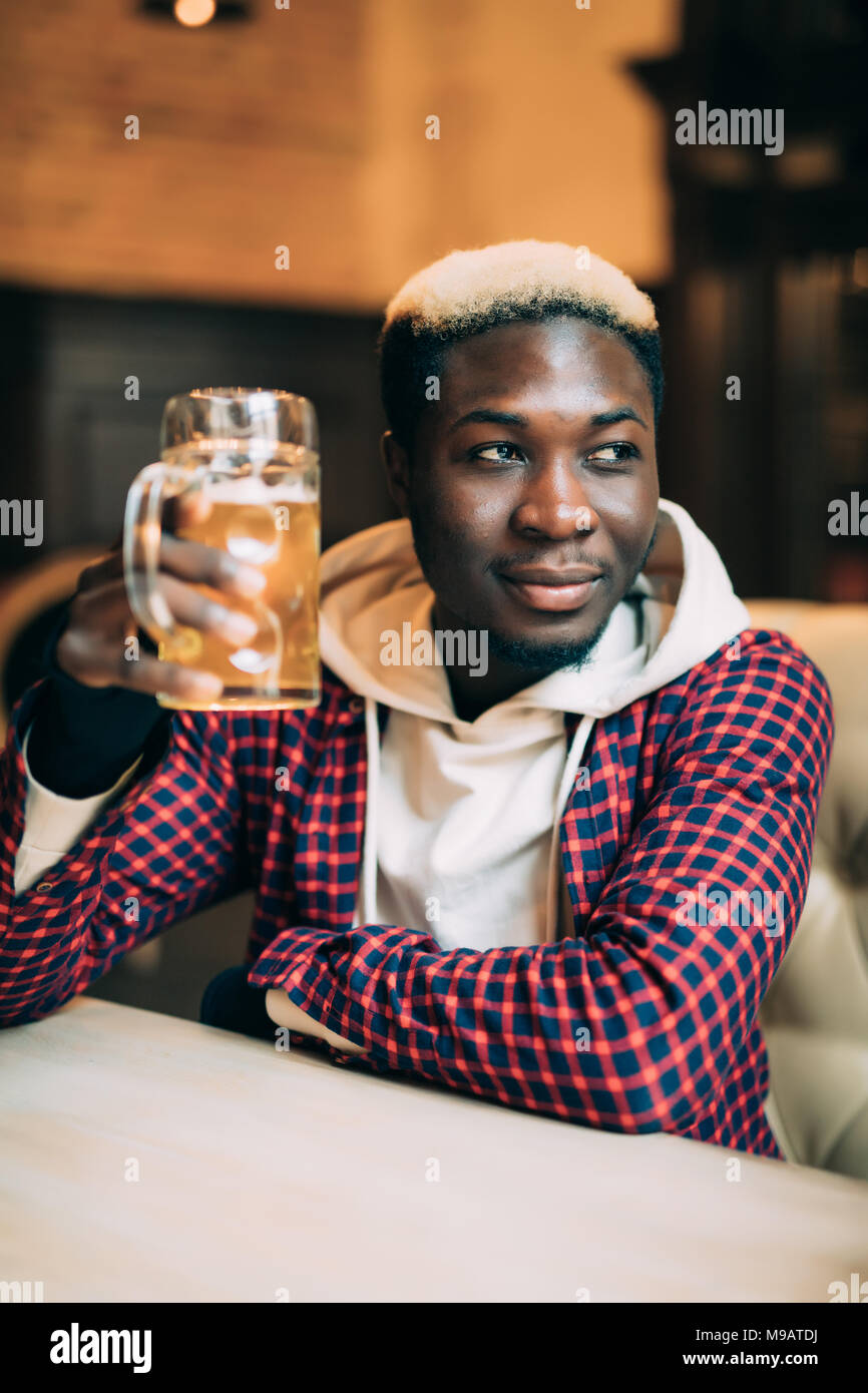 African American man with drink at bar Stock Photo - Alamy