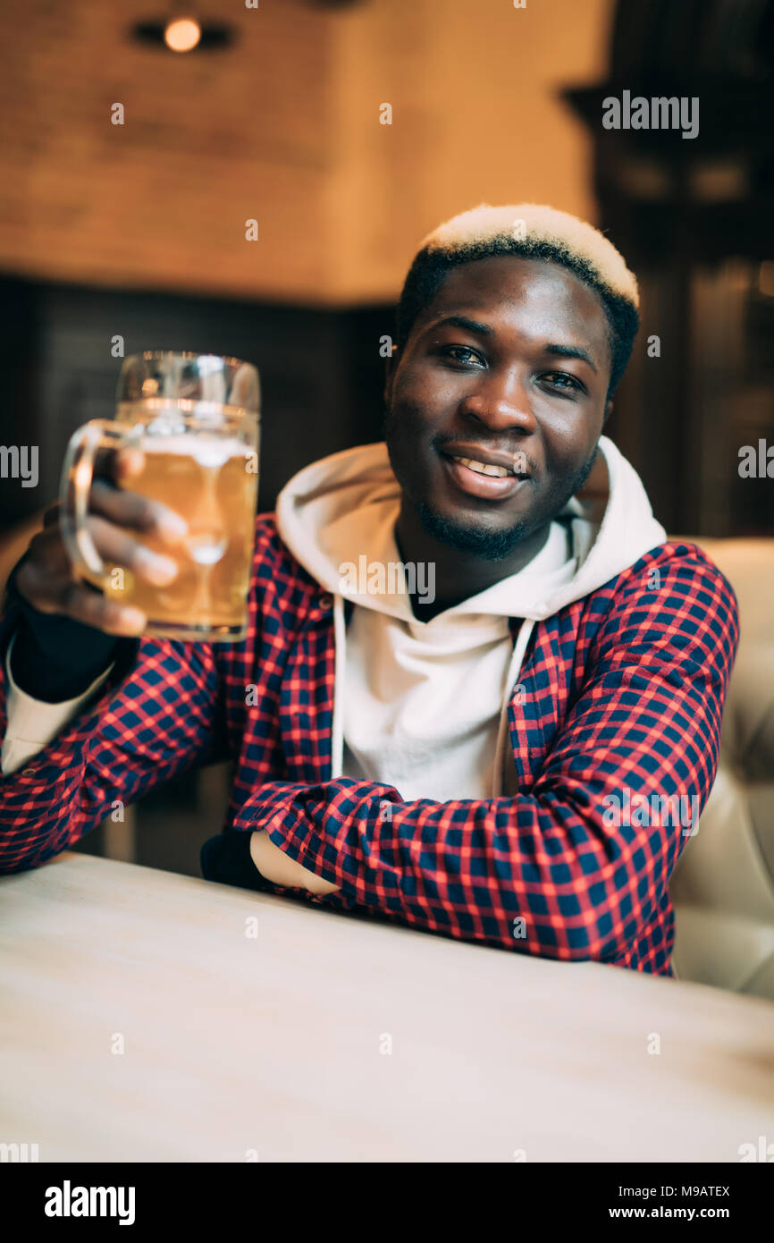 African American man with drink at bar Stock Photo Alamy