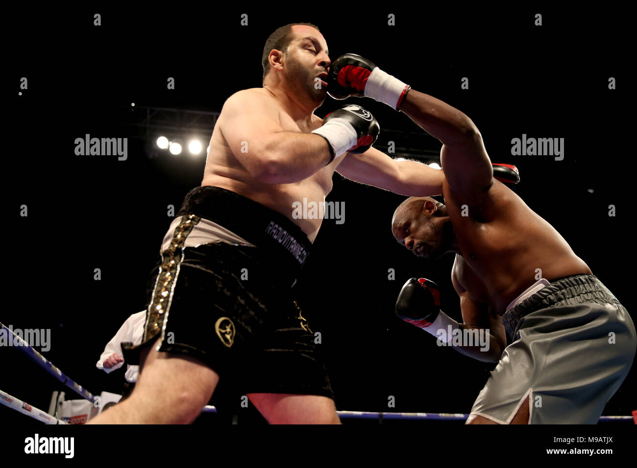 Dereck Chisora (right) in action against Zakaria Azzouzi (left) in the first round of the Heavyweight contest at the O2 Arena, London. Stock Photo