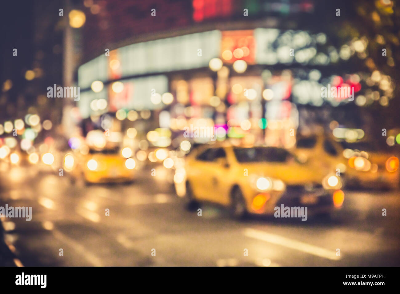 Defocus blur of New York City street scene at night with cars and ...