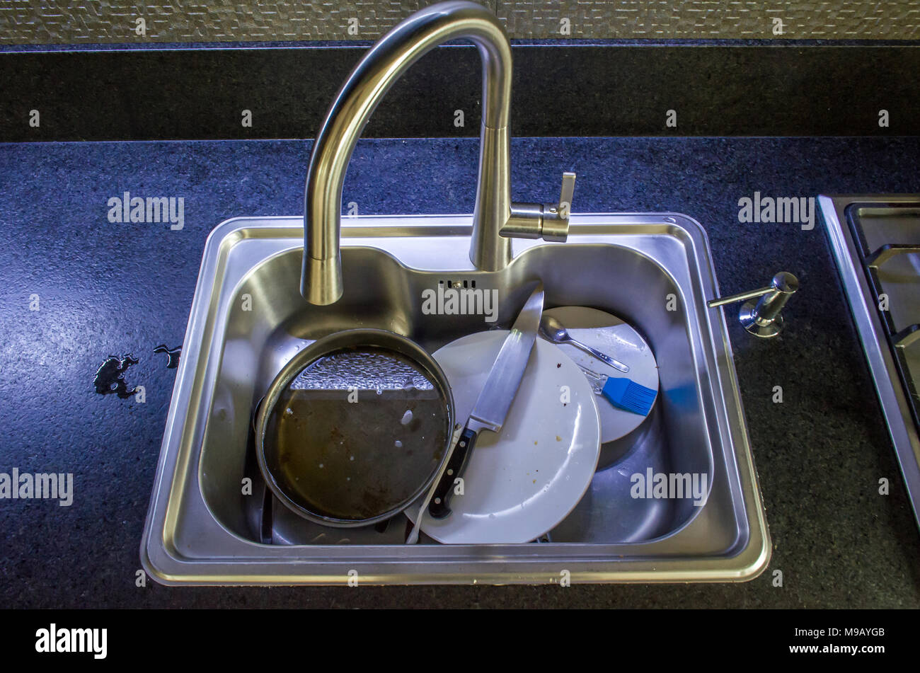 Unwashed dishes in sink close Stock Photo