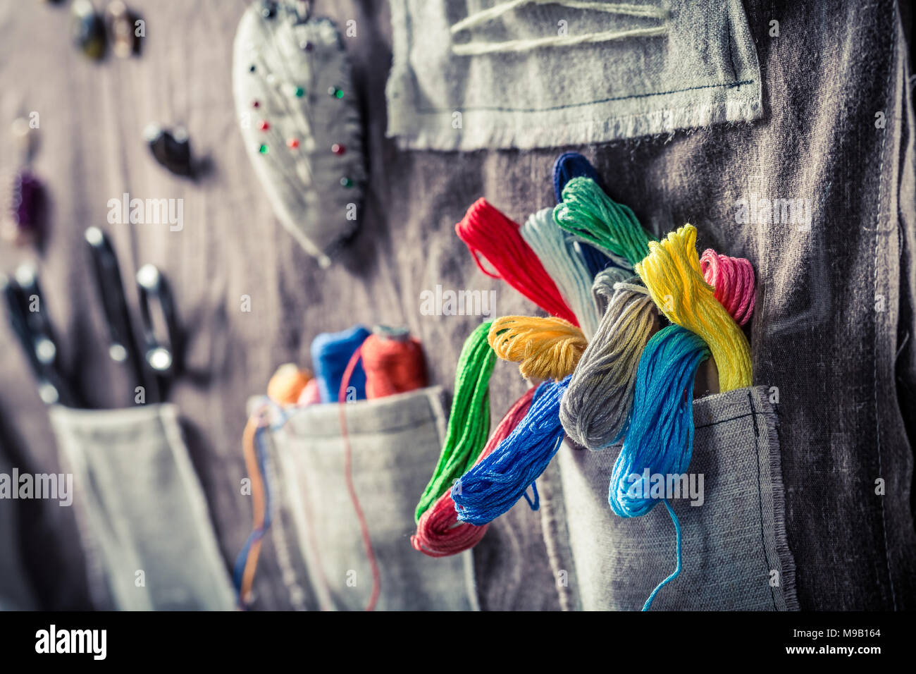 Colored threads, buttons and scissors in the mat tailor Stock Photo
