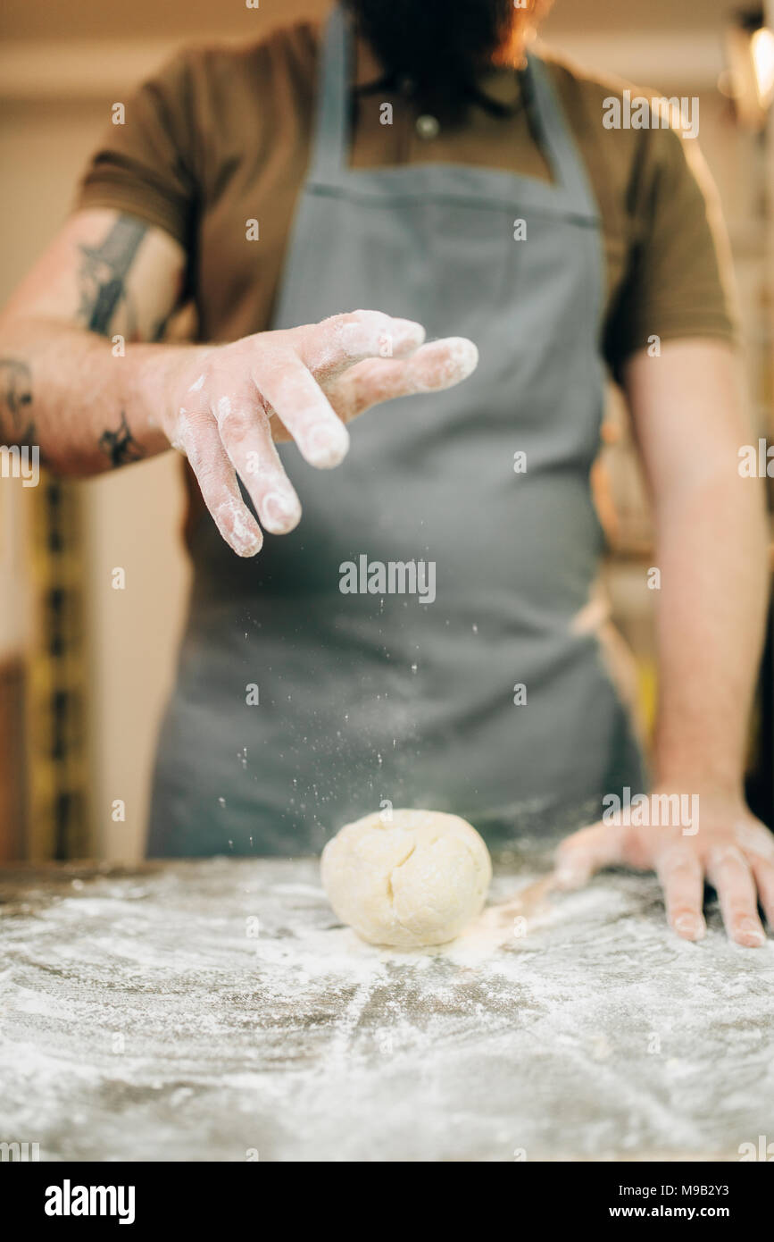 Fresh pasta cooking, chef in apron makes dough Stock Photo